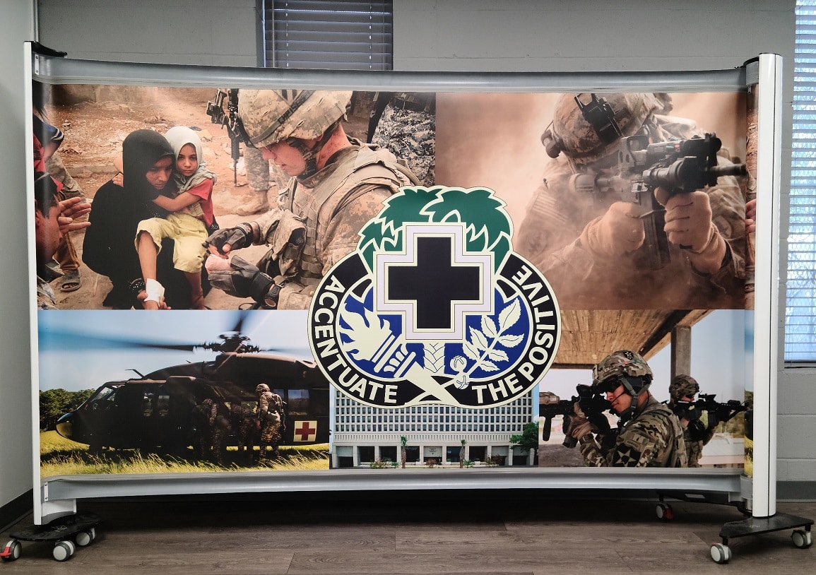 Rolascreen partition with Moncrief Army Health Clinic Army Medicine branding deployed at a military health facility