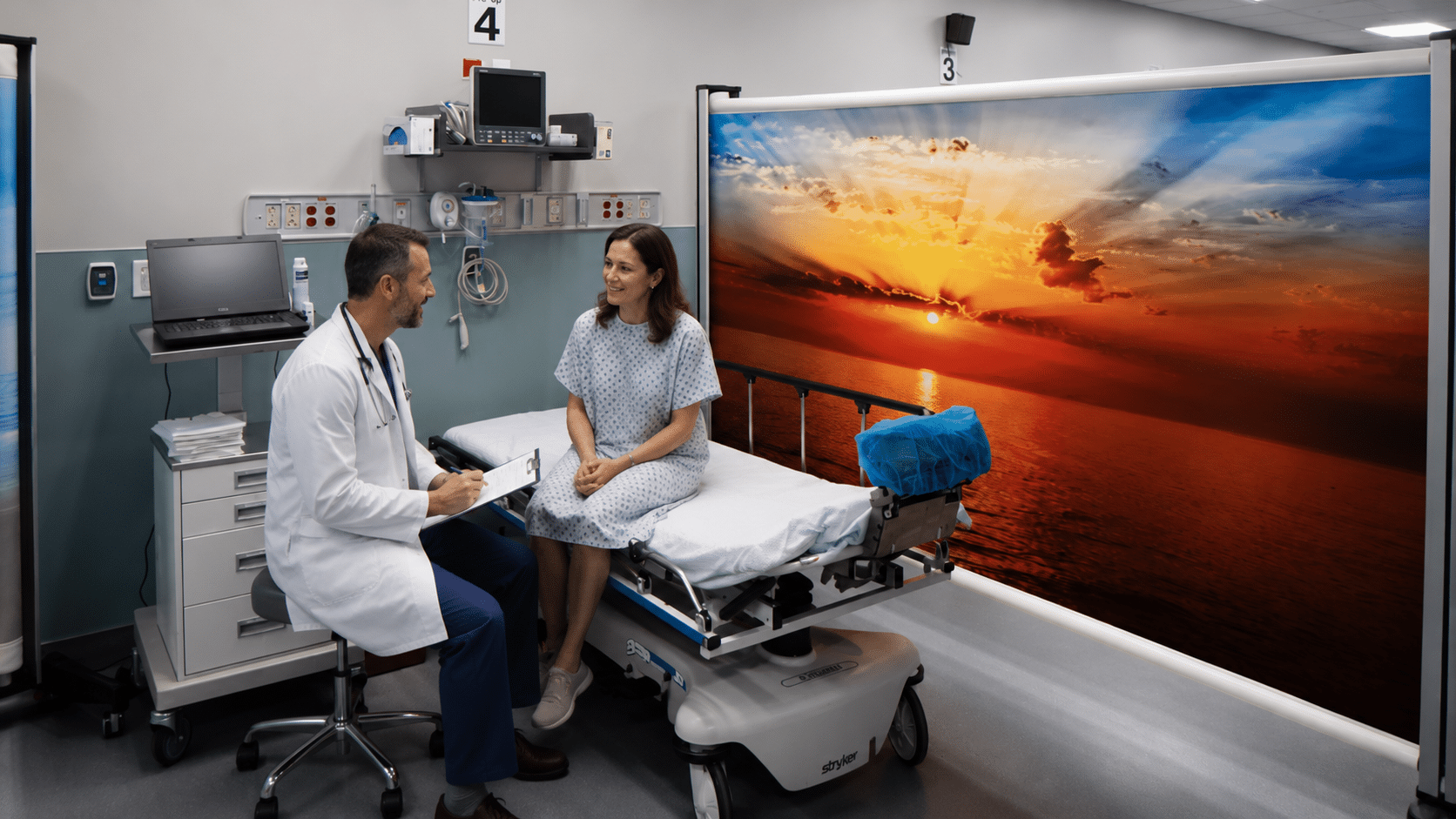 Portable Rolascreen privacy screen creating a private consultation space between a physician and patient in a hospital bay